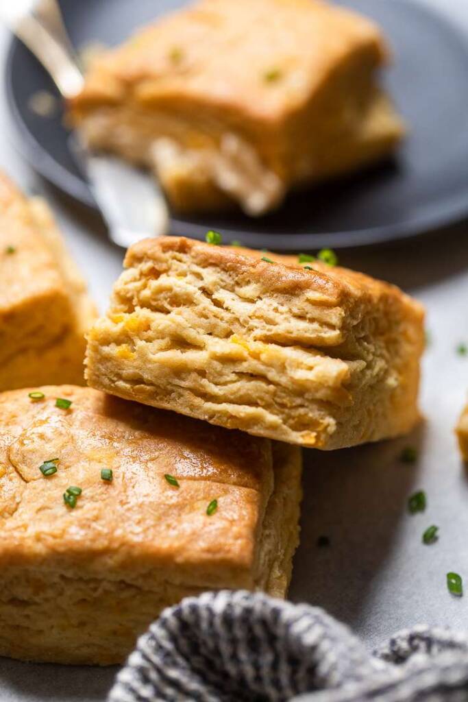 A close up of layers on vegan maple cheddar buttermilk biscuits.