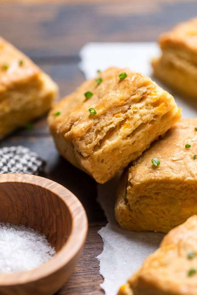 A close up of a few vegan maple cheddar buttermilk biscuits.