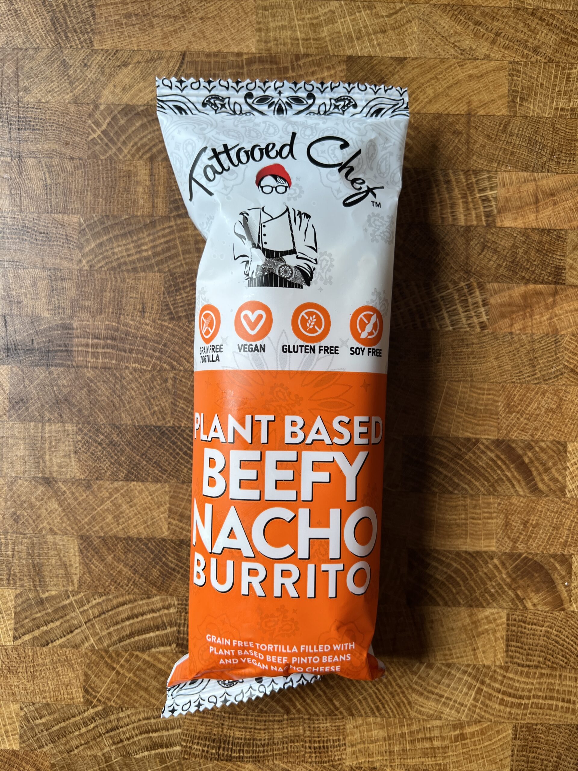 Tattooed chef vegan plant-based Beefy Nacho Burrito package. 