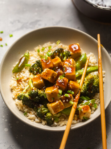A bowl of Teriyaki Tofu and Broccoli with extra sauce on top.