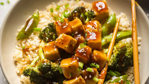 A bowl of Teriyaki Tofu and Broccoli with extra sauce on top.