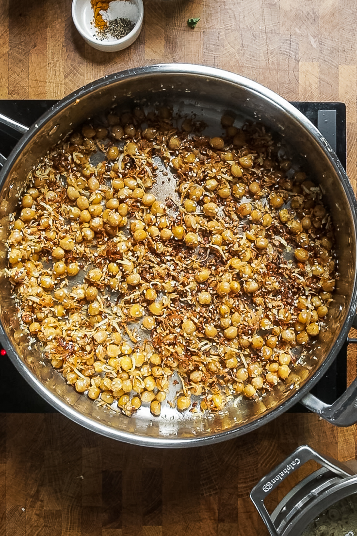 coconut and chickpeas cooking in a skillet. 