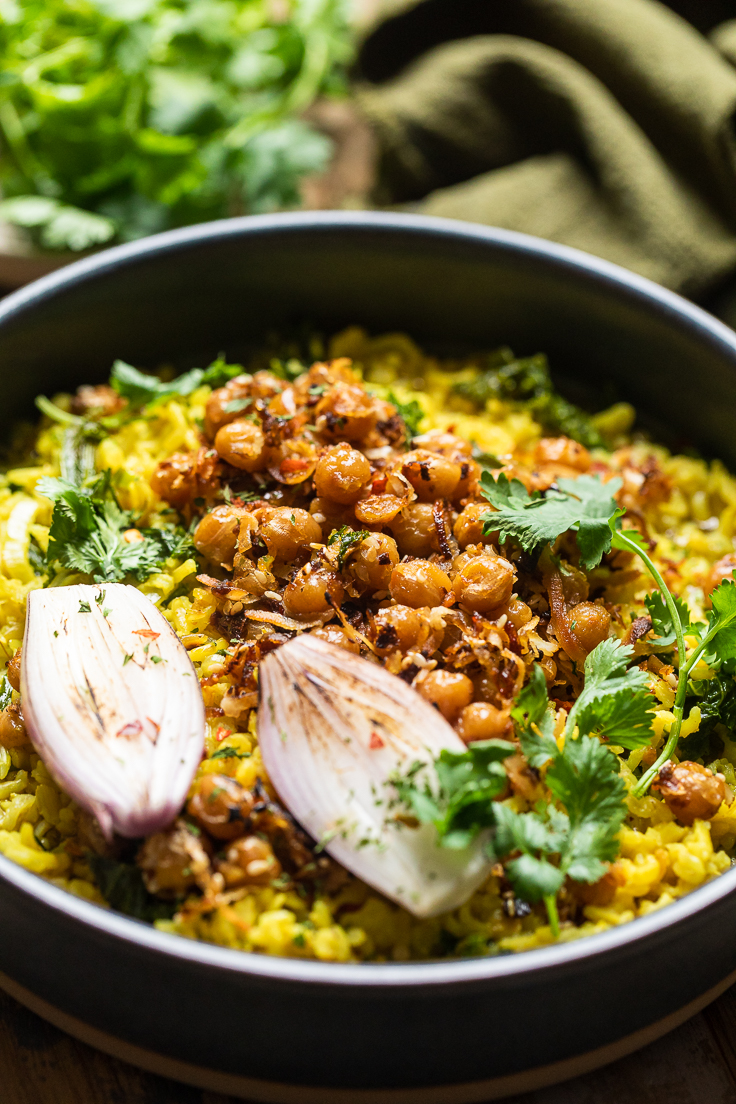 spiced coconut chickpeas over creamy turmeric rice in a bowl.