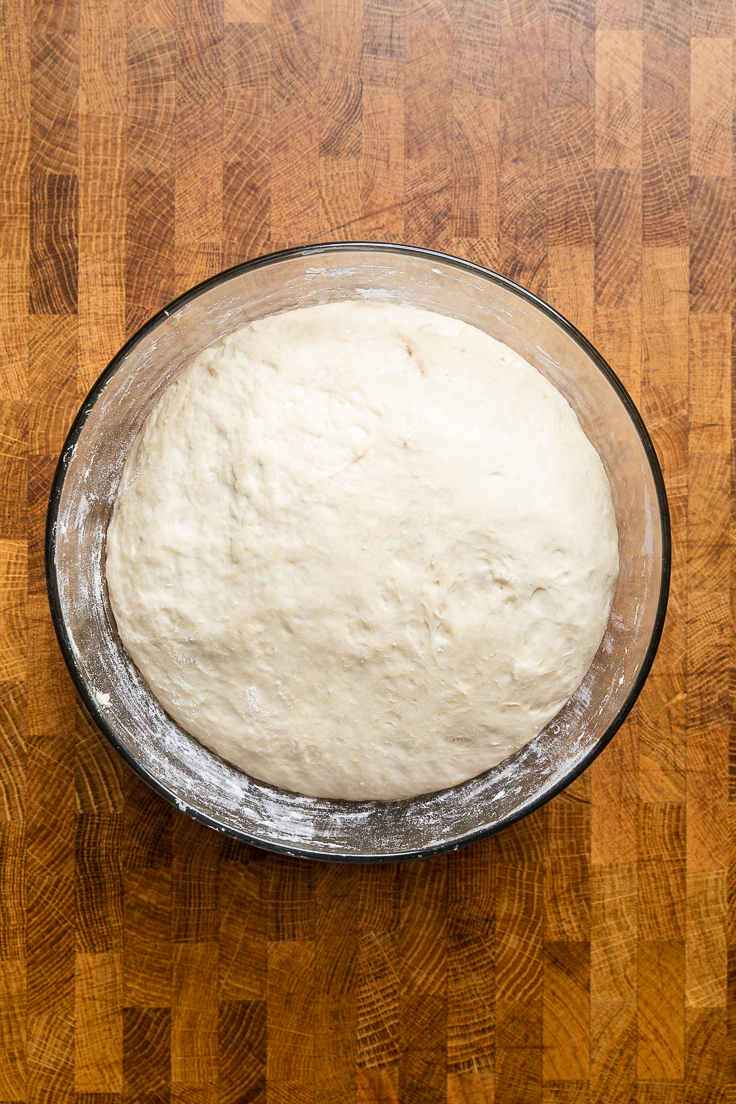Easy vegan white bread dough after rising in a bowl.