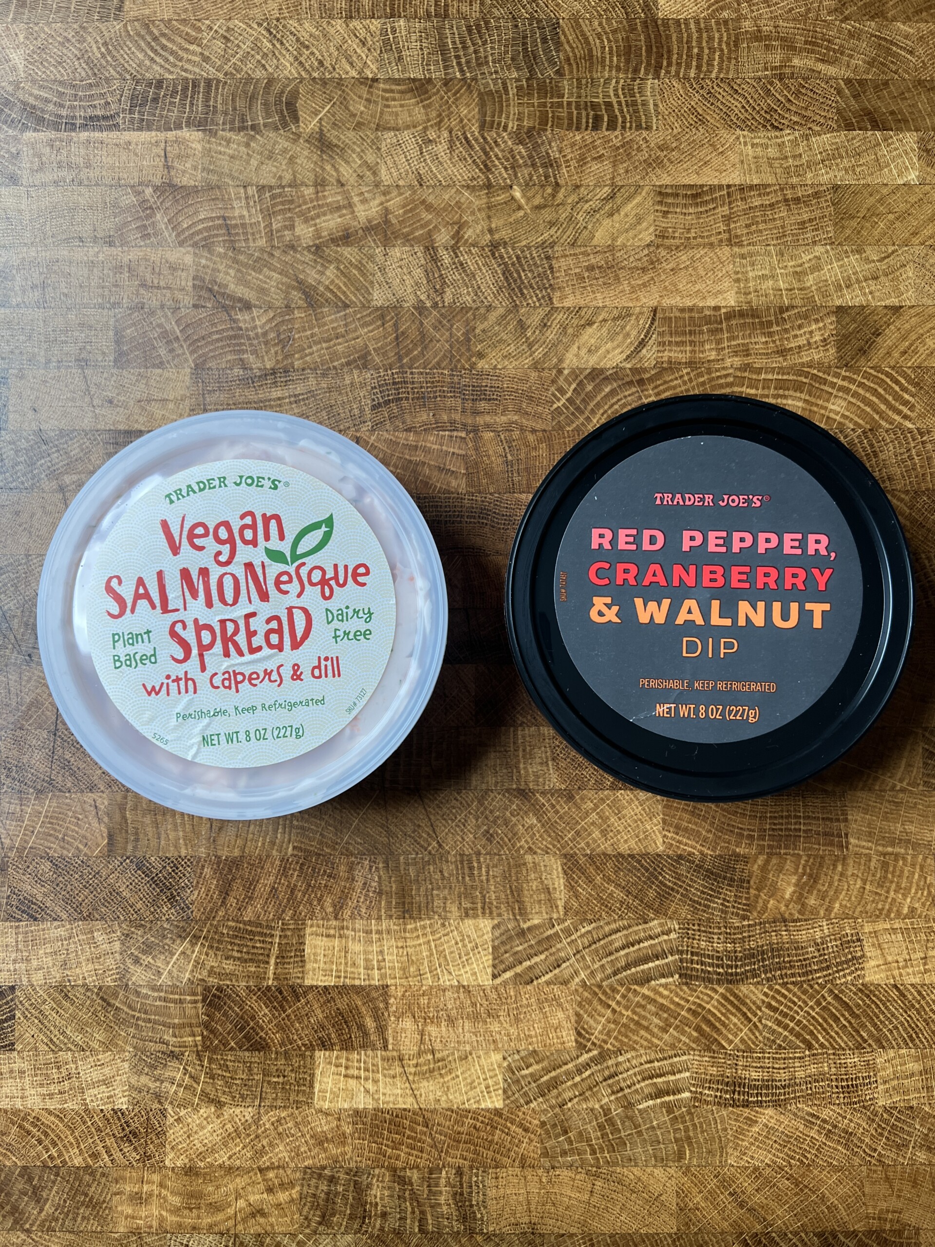 A container of Trader Joe’s Vegan Salmonesque Spread and Trader Joe\'s red pepper, cranberry & walnut dip.