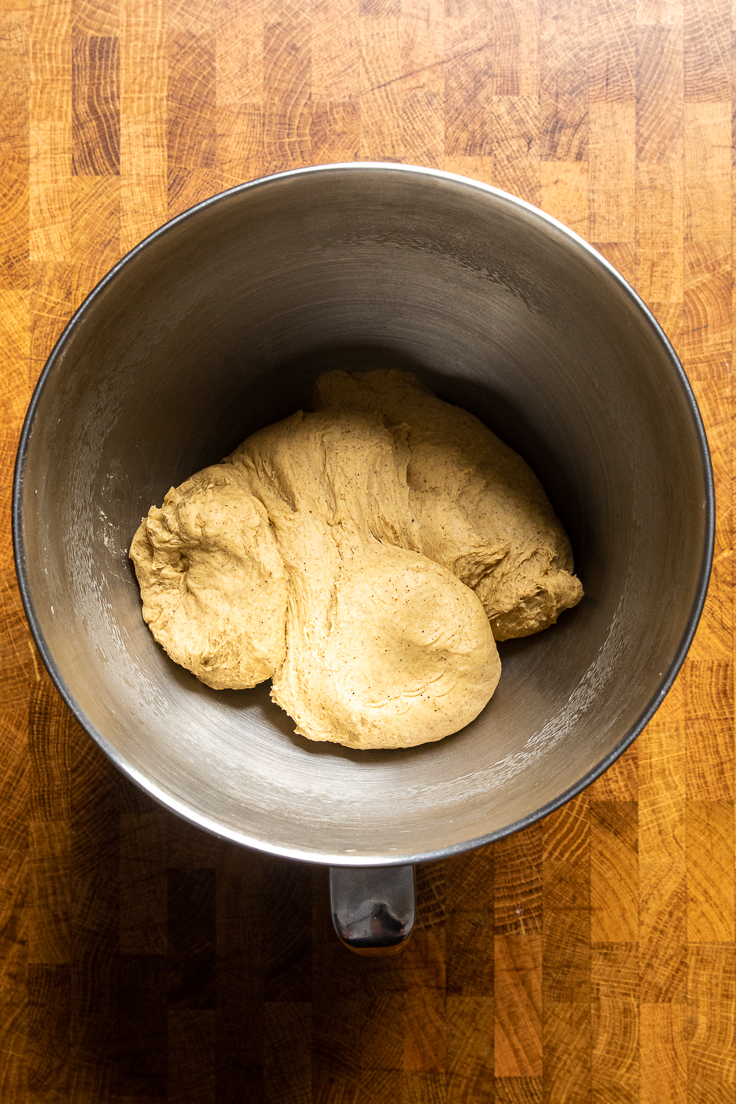 A bowl of vegan pumpkin cinnamon roll dough. 