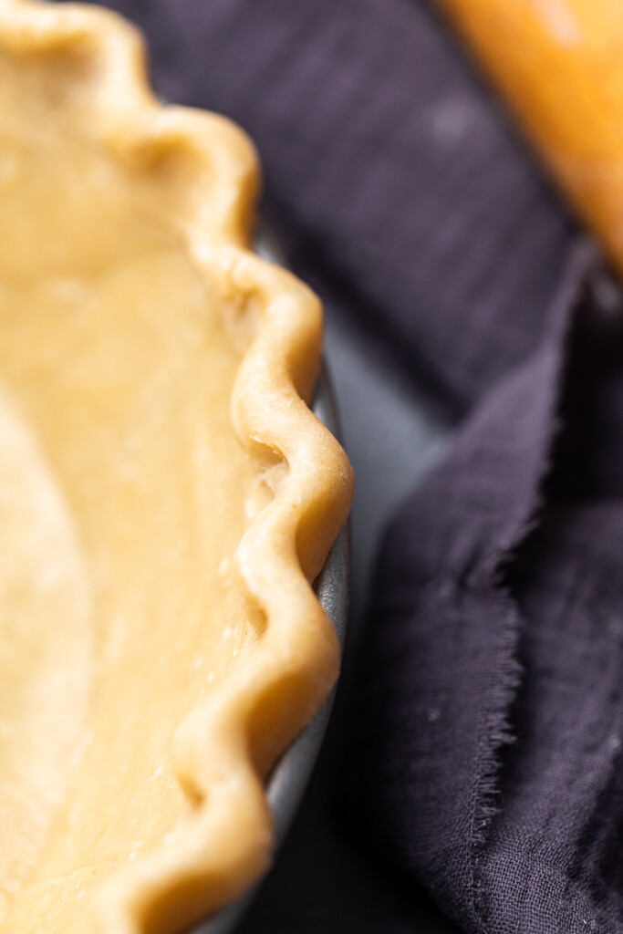 close up of scalloped edging on a pie crust. 