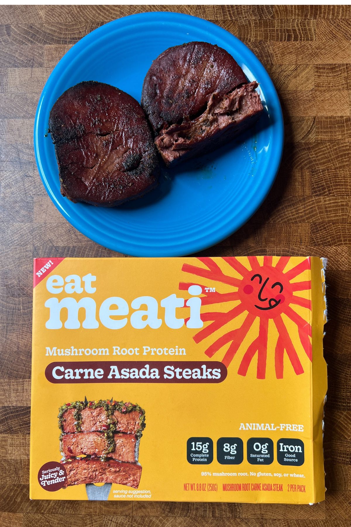 meati foods carne asada steaks cooked on a plate and the package beside it.