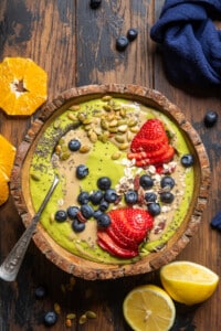 vegan green smoothie bowl on a table.