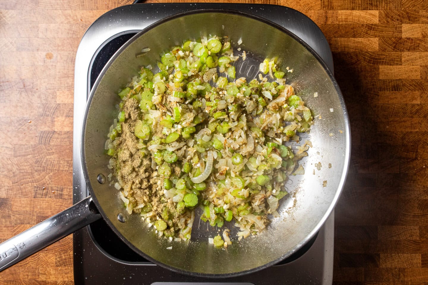 vegetables sauting in a skillet to make stuffing.