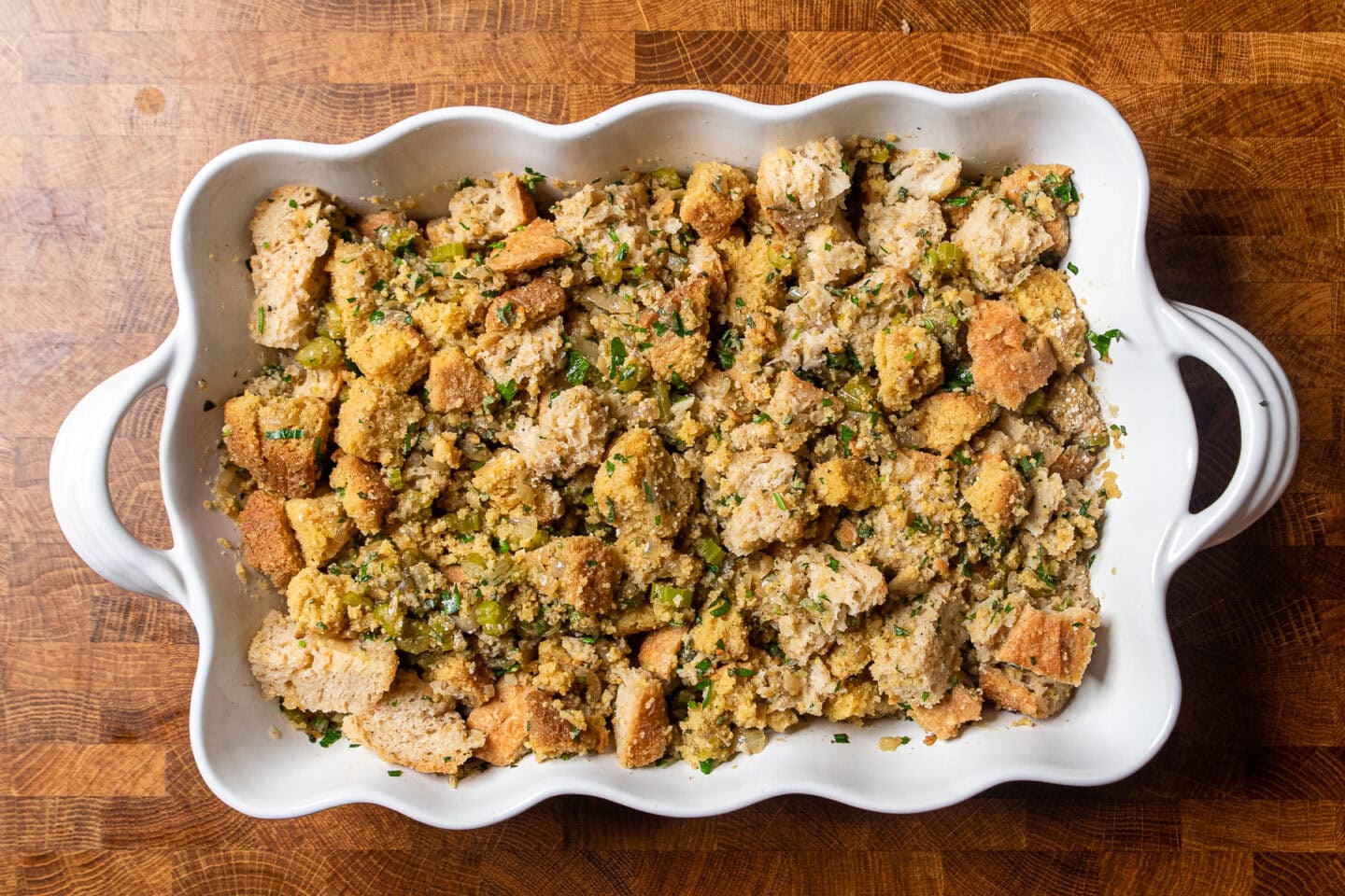 vegan cornbread and sourdough stuffing in a white casserole dish.