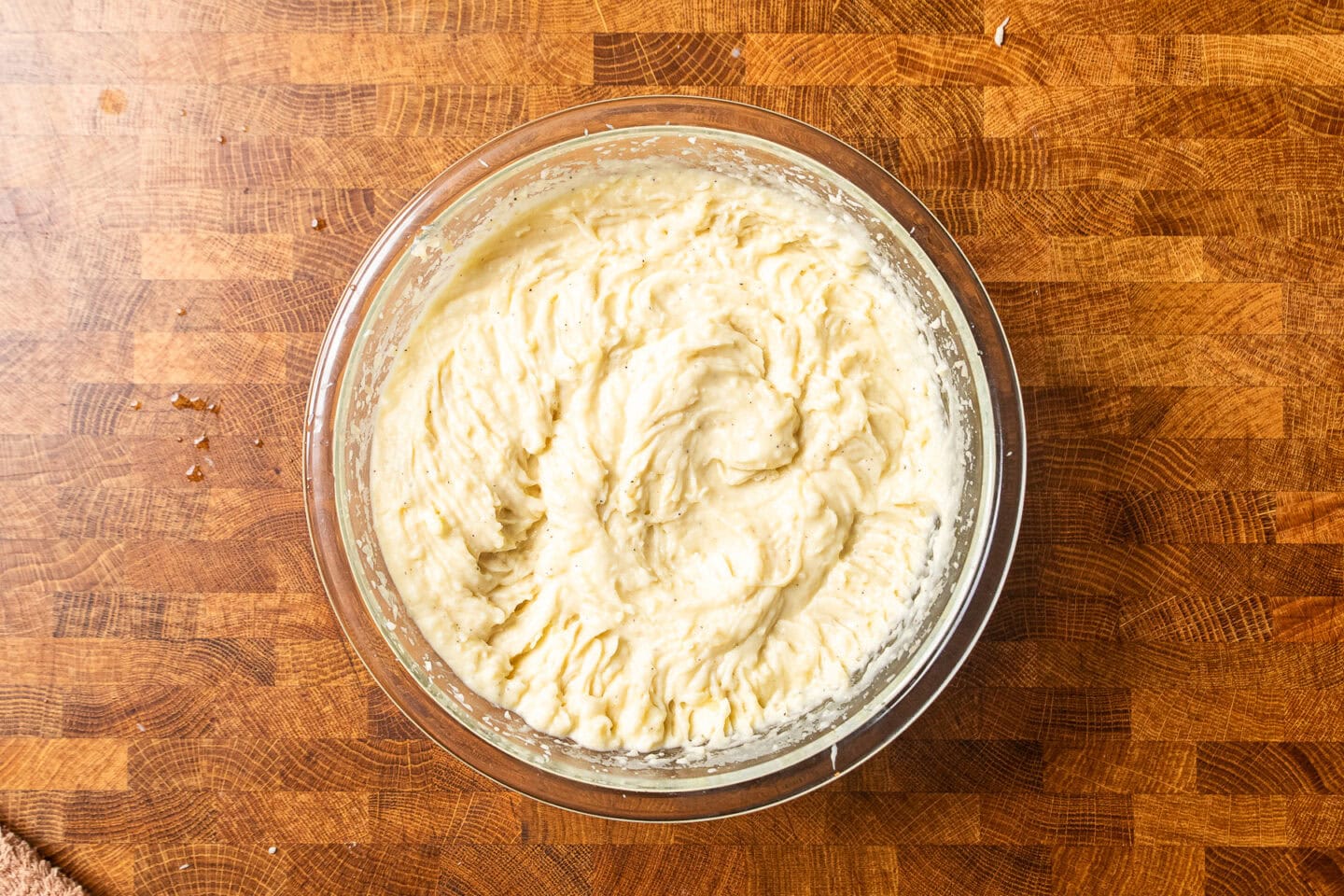 creamy roasted garlic mashed potatoes in a large glass bowl.