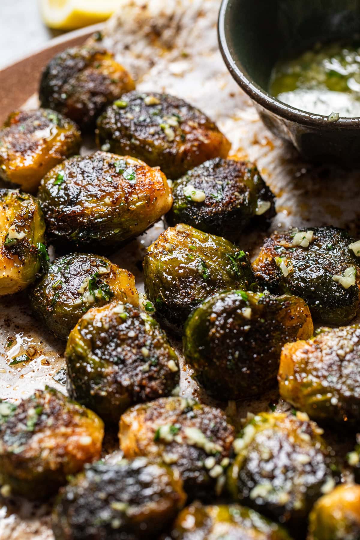 close up of vegan smashed brussels sprouts with a lemon garlic butter sauce.