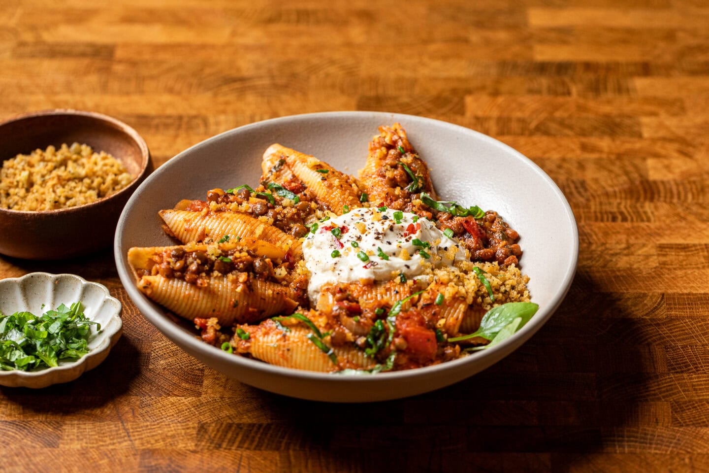 a bowl of unstuffed lentil shells, whipped vegan ricotta and toasted breadcrumbs.