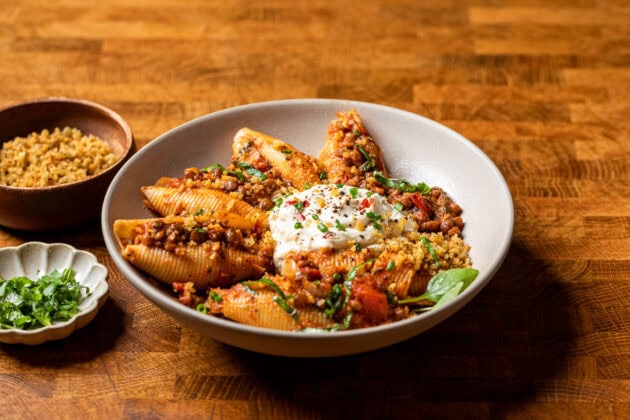 a bowl of unstuffed lentil shells, whipped vegan ricotta and toasted breadcrumbs.