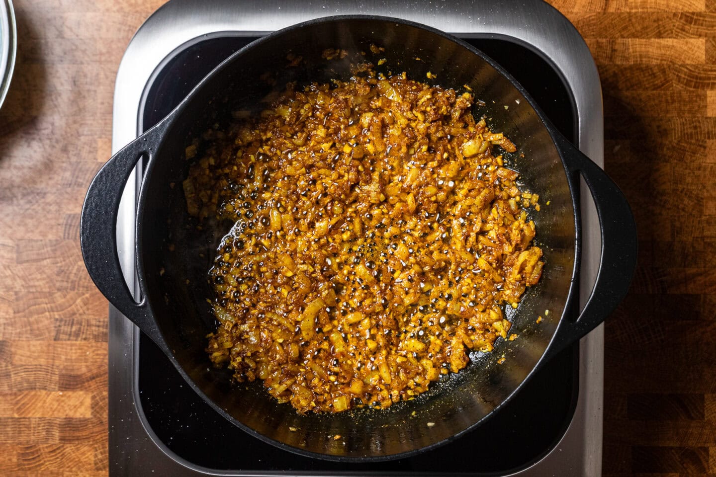seasoned onions, garlic, and ginger sauting in a pot.
