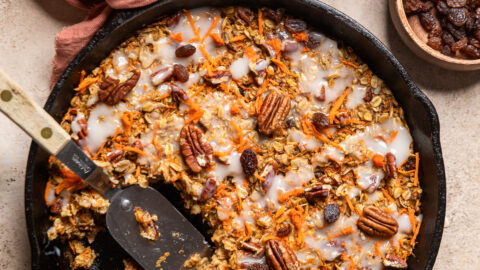 vegan carrot cake baked oatmeal in a cast iron skillet.