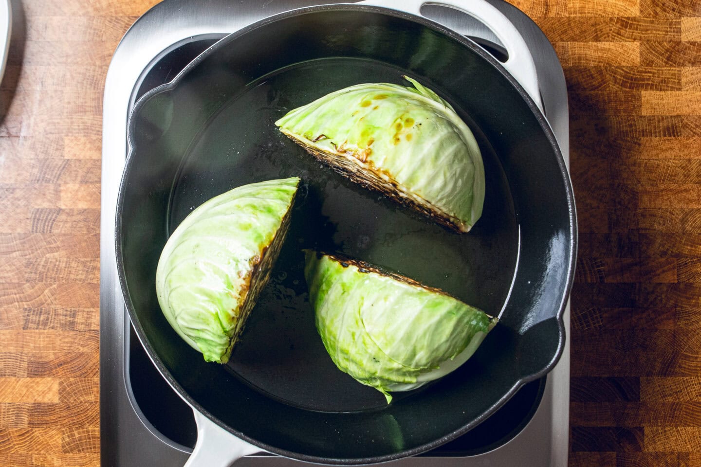 cabbage searing in a skillet.
