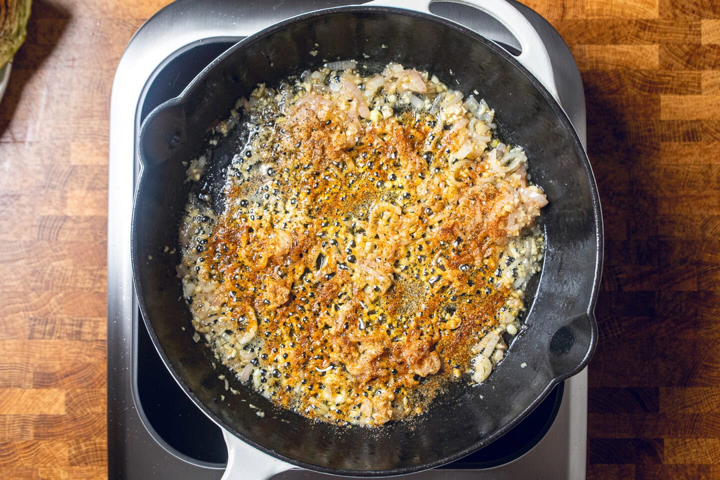 shallots, garlic, and spices sauting in skillet.