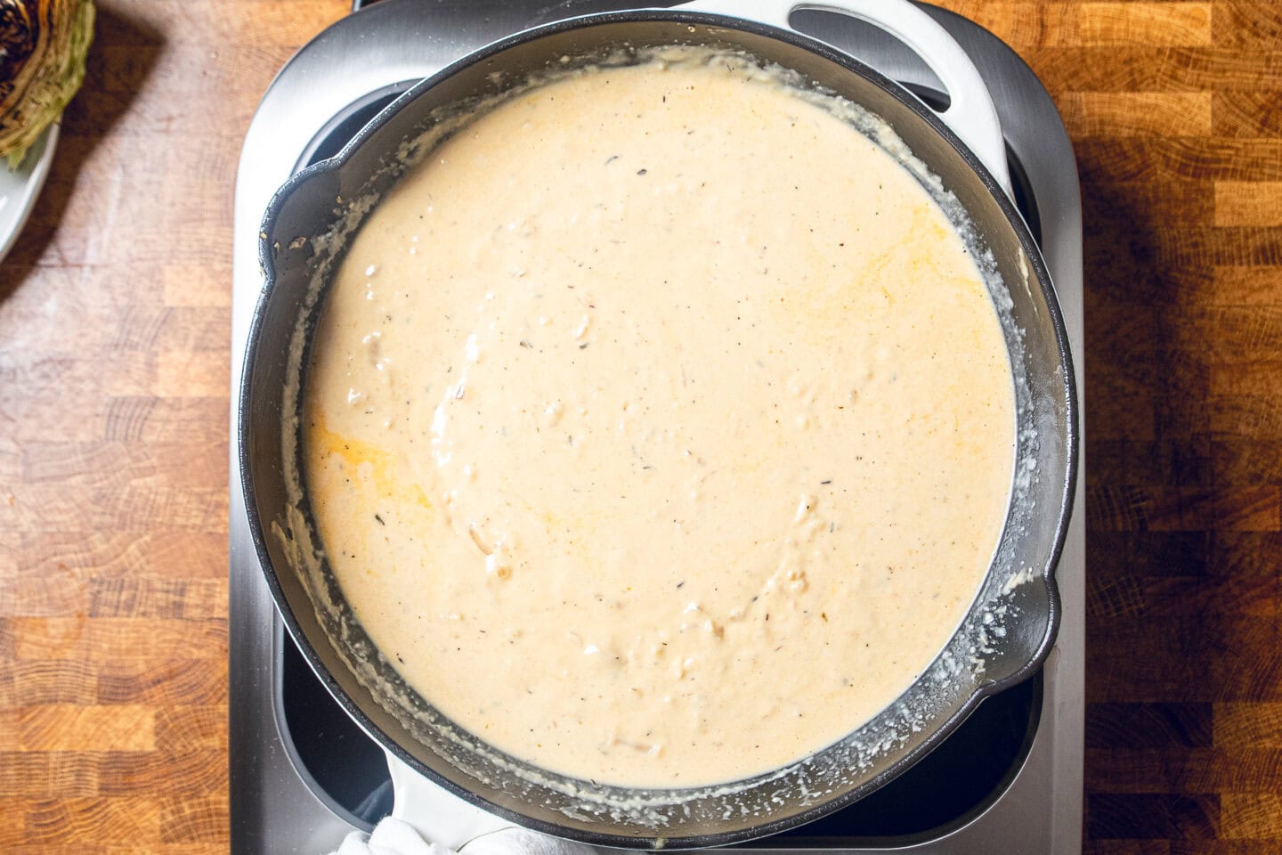 vegan miso garlic butter sauce simmering in a pan.