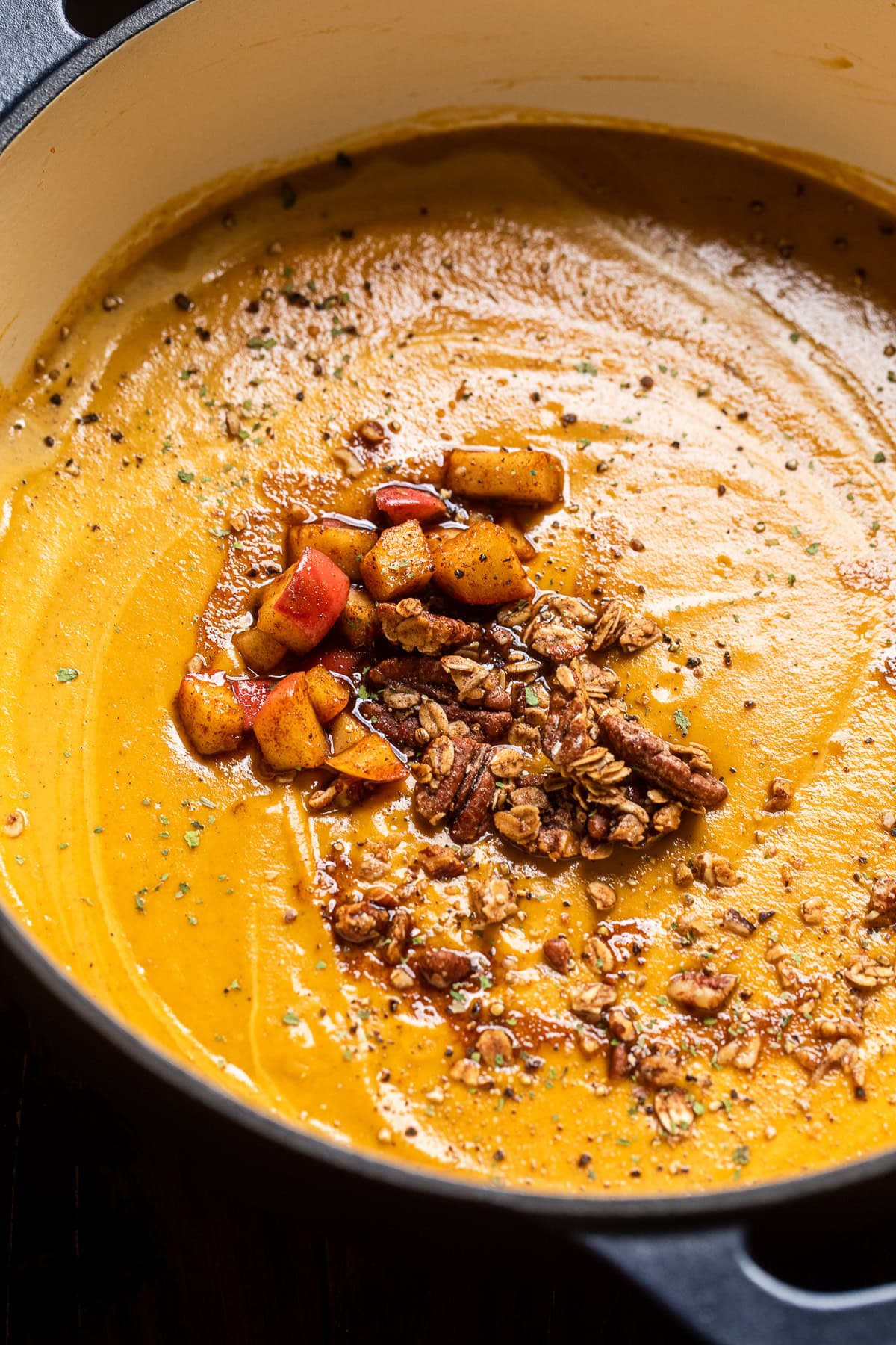 close up of Roasted Sweet Potato and Apple Bisque and pecan crumble on top.
