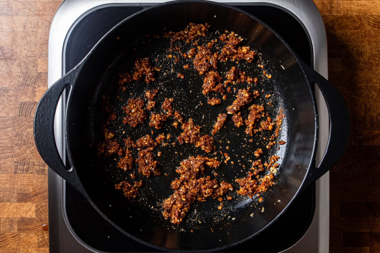 chili oil crunch, garlic, and ginger cooking in a large pot.