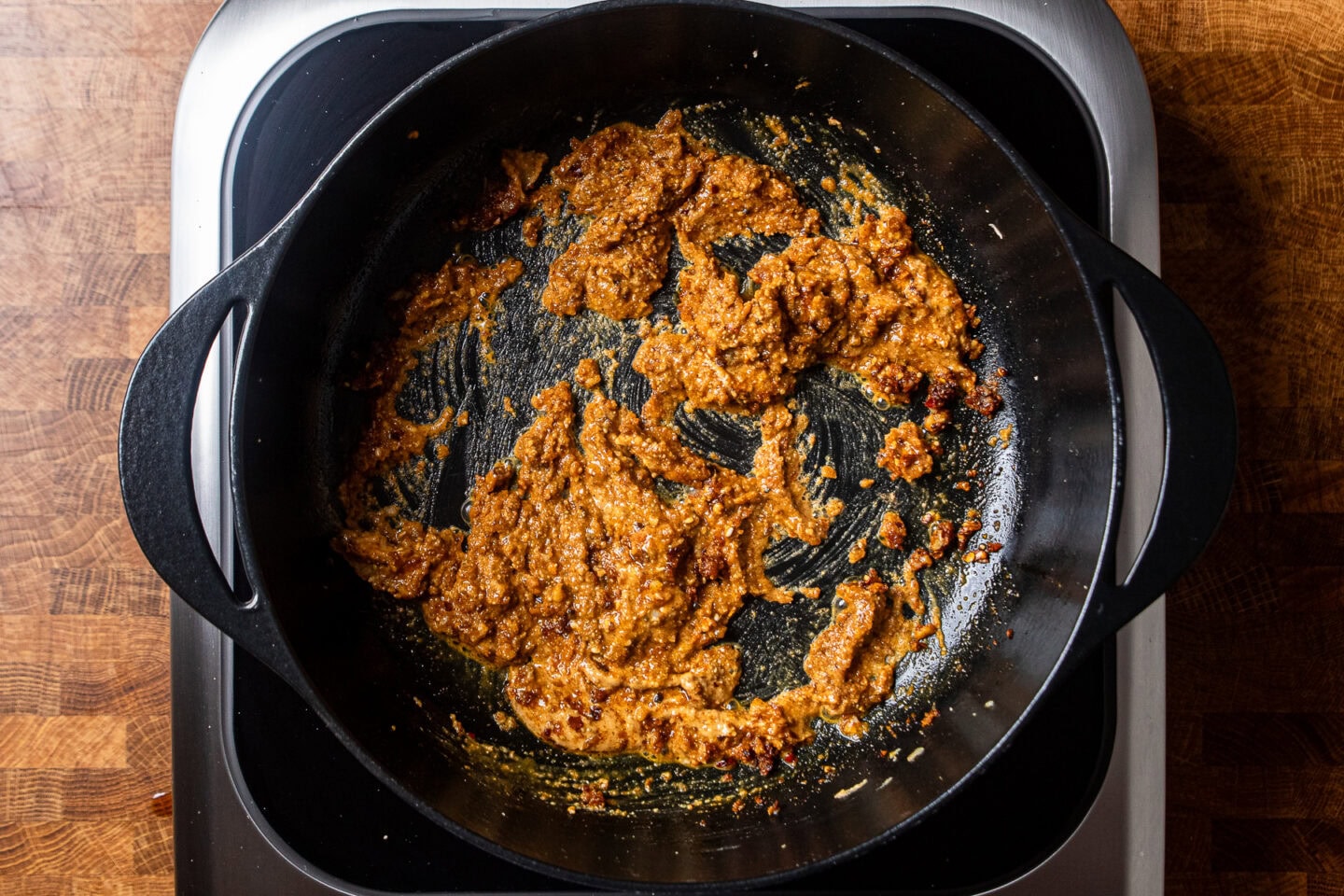 a blend of peanut butter and aromatics with spices cooking in a large pot.