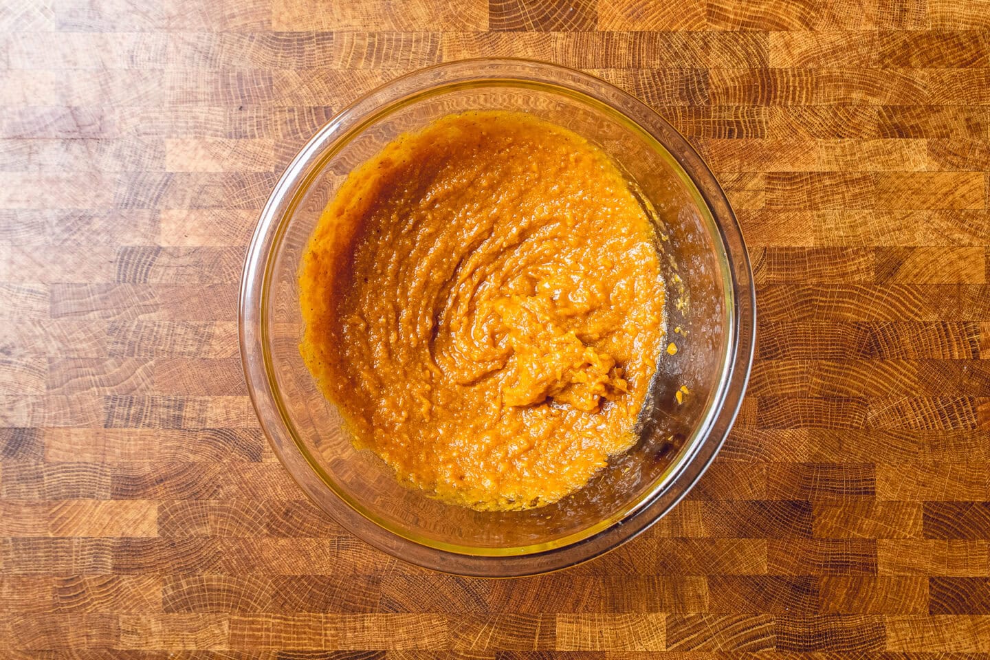 wet ingredients for sweet potato brownies mixed together in a glass bowl.
