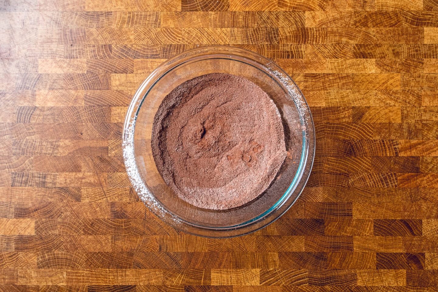 dry ingredients to make sweet potato brownies mixed together in a glass bowl.