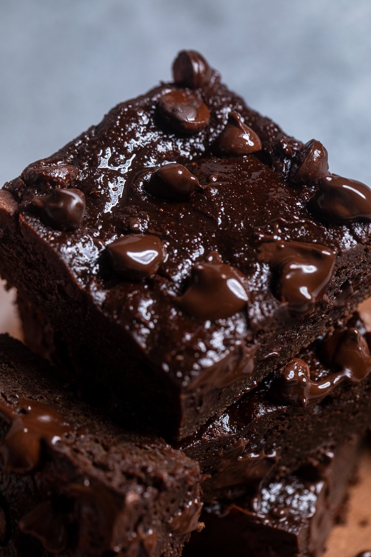 close up of a sweet potato brownie with melted chocolate chips on top.
