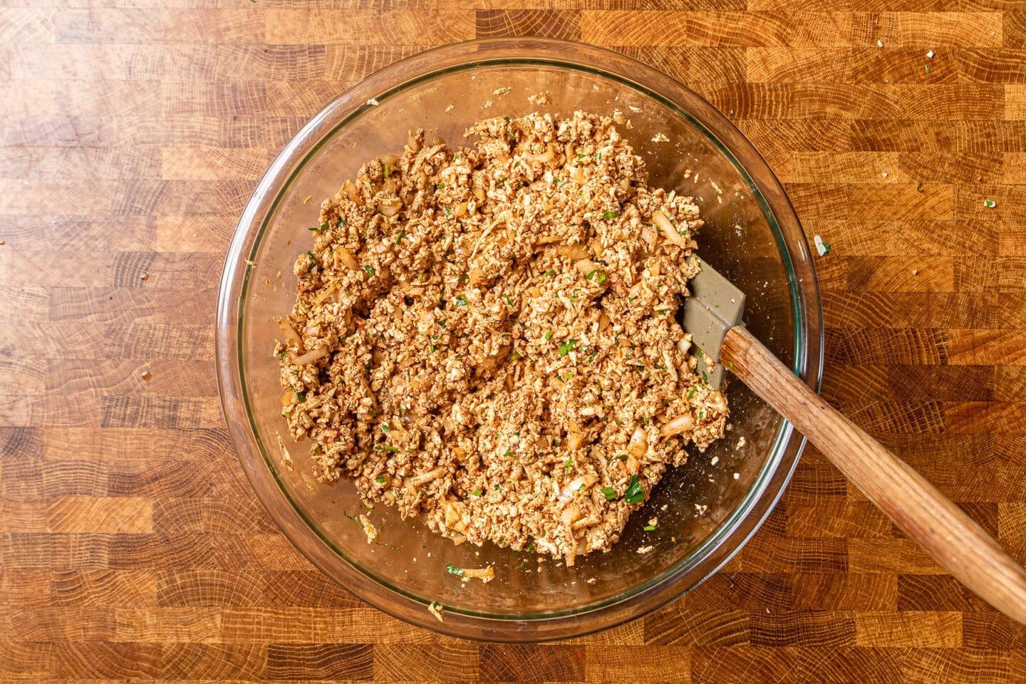 seasoned tofu pieces in a large glass bowl.