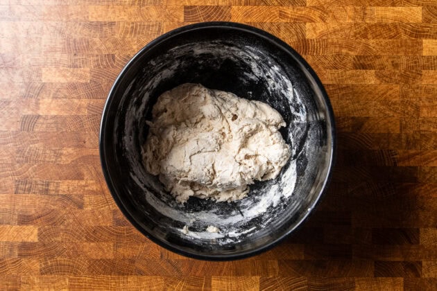 a shaggy dough in the black mixing bowl.