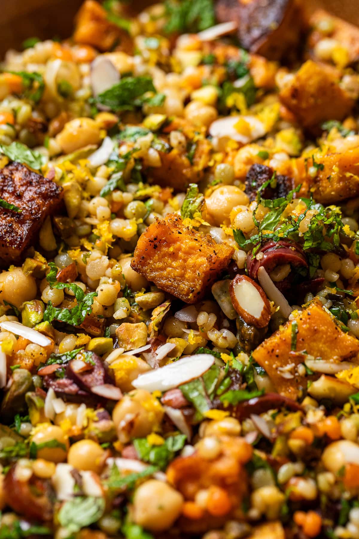close up of roasted sweet potato citrus moroccan-couscous salad.