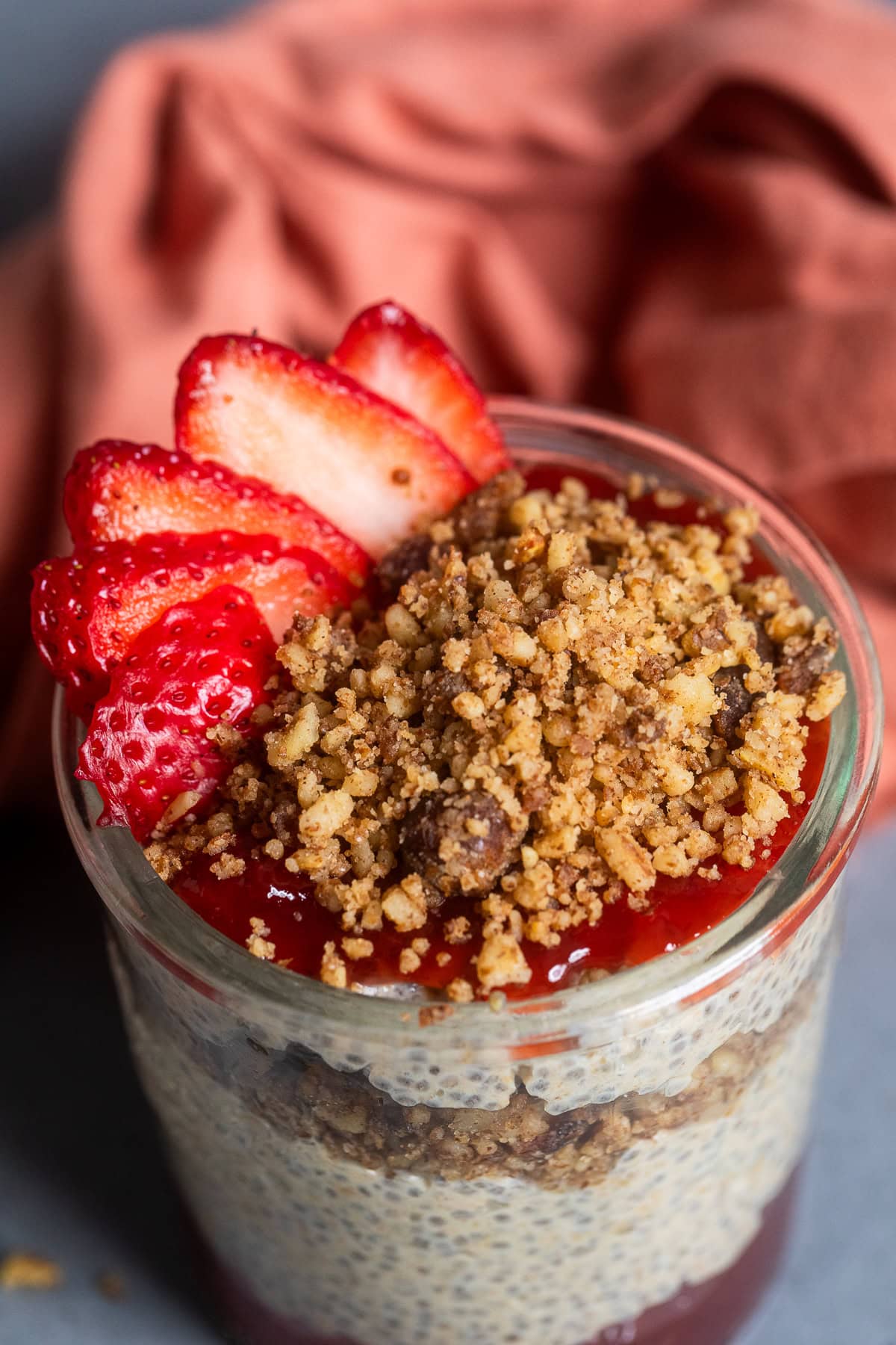 top down image of chia seed pudding with strawberry slices and granola.