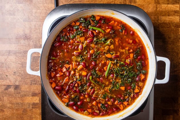 chipotle red beans and kale finished cooking in a skillet.