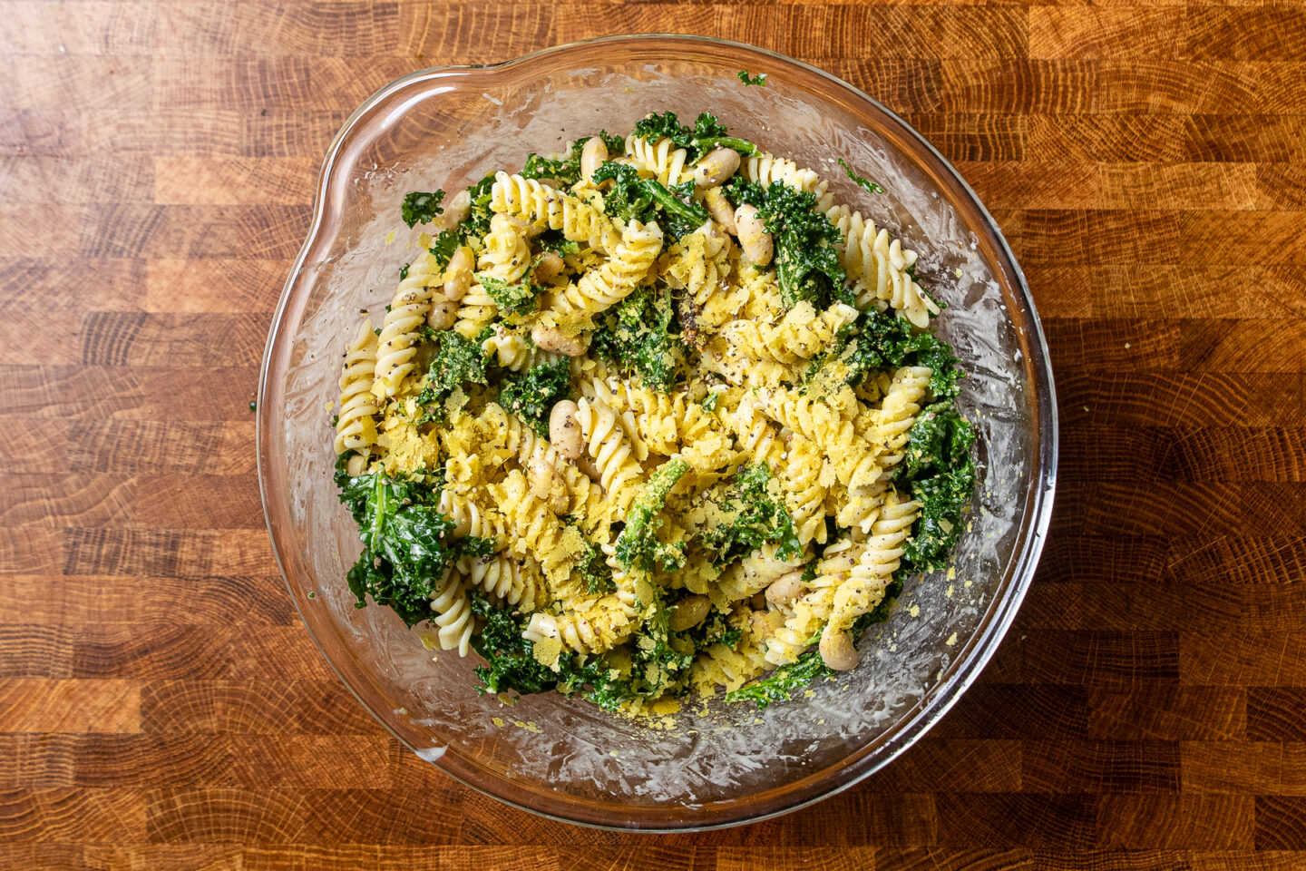 caesar pasta salad with kale in a bowl