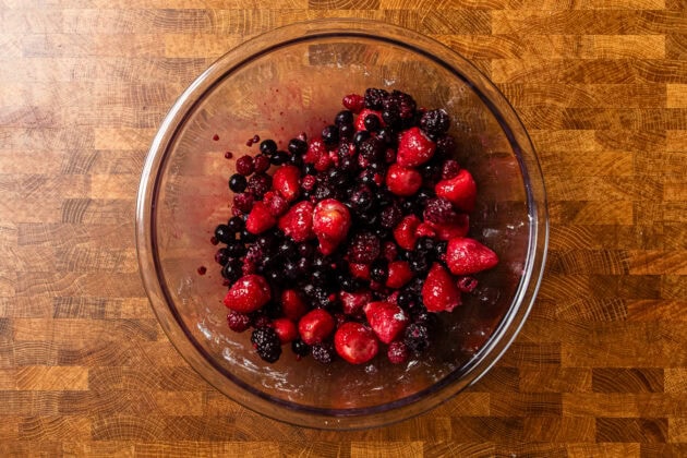 a bowl of mixed berries on a table.