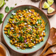 mexican street corn salad with chickpeas in a green bowl.