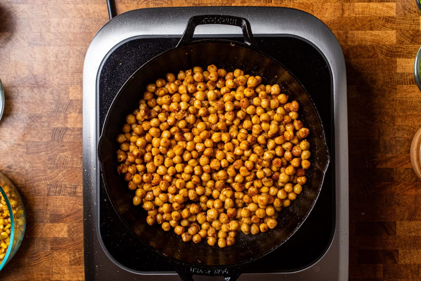 chickpeas cooking in a cast iron skillet.