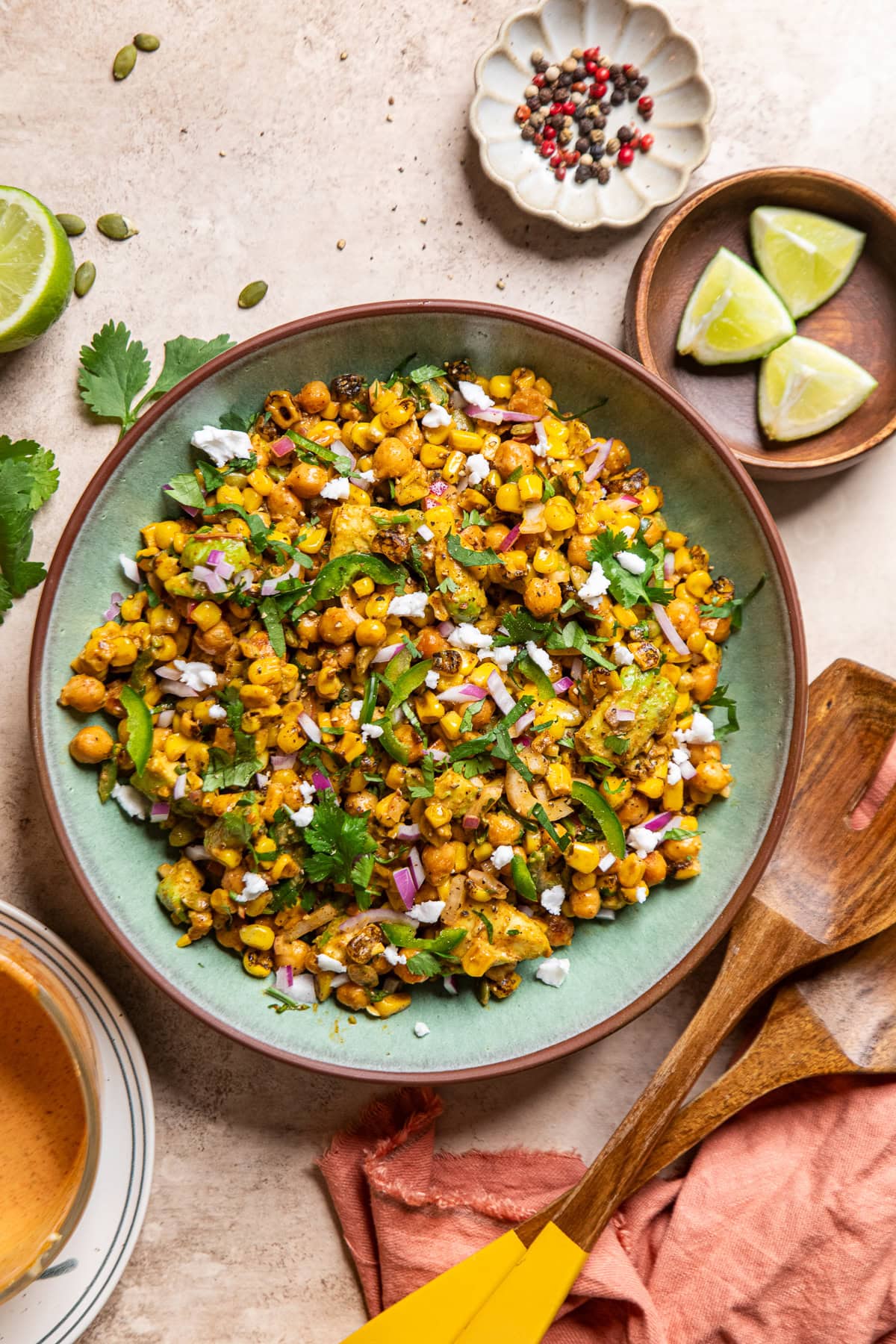 mexican street corn salad with chickpeas in a green bowl.