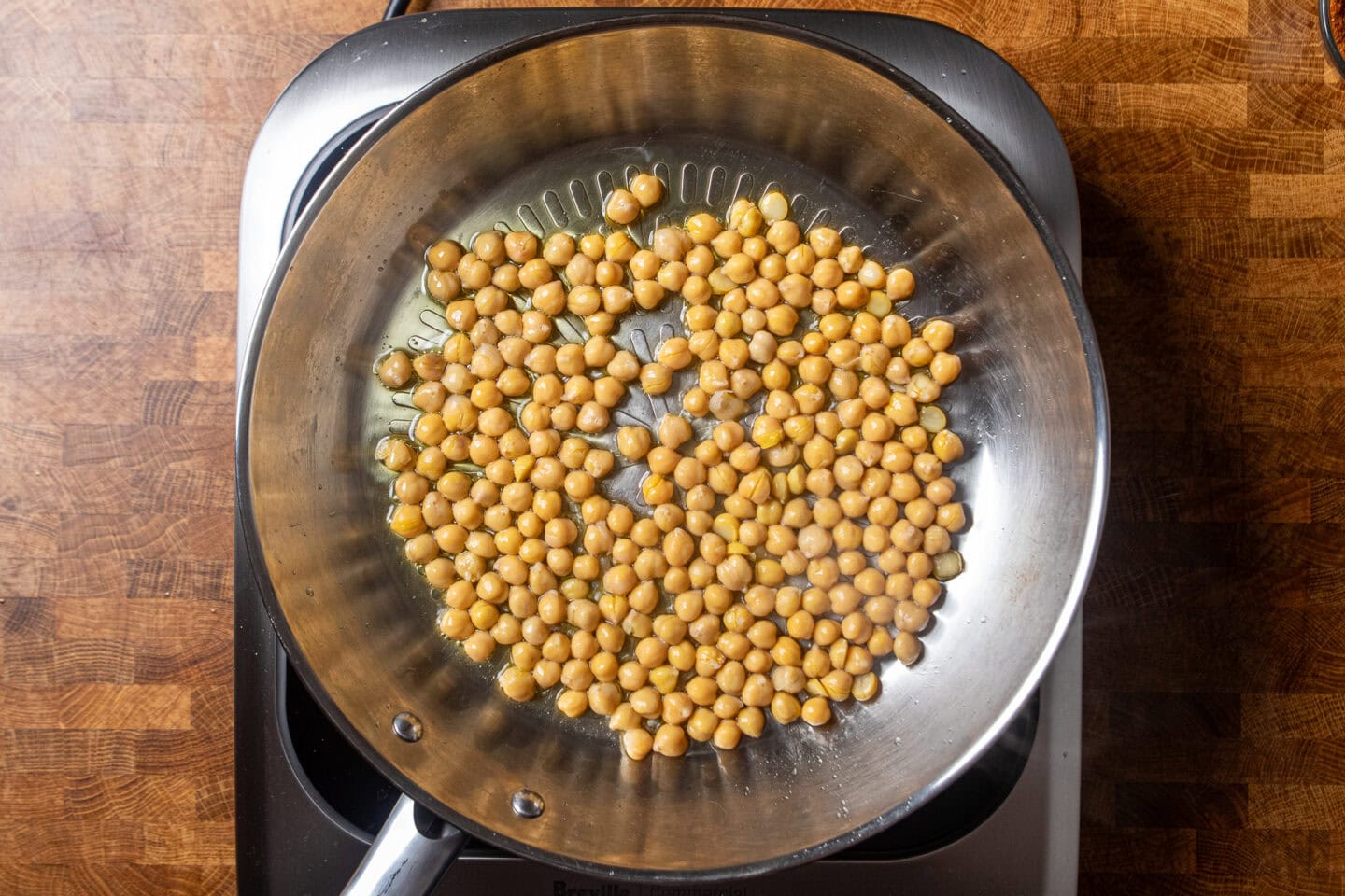 chickpeas crisping in a skillet.