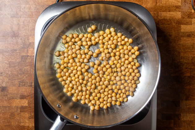 chickpeas crisping in a skillet.