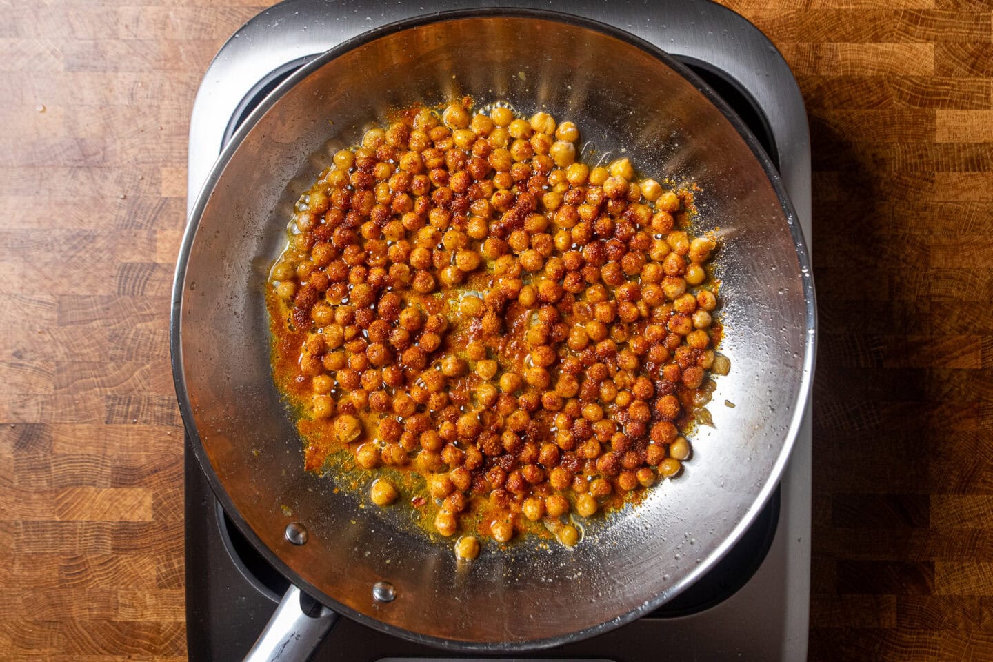 seasoned chickpeas cooking in a skillet.