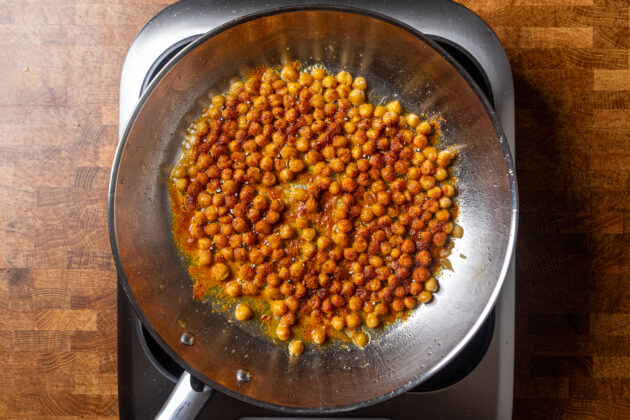 seasoned chickpeas cooking in a skillet.