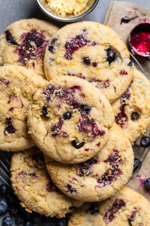 vegan lemon blueberry cookies stacked in a pile.