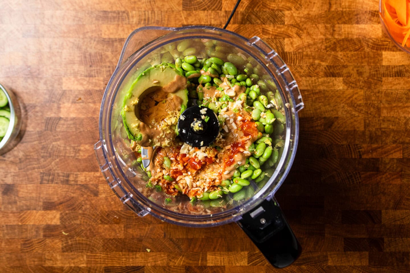 ingredients to make spicy edamame spread in a food processor.