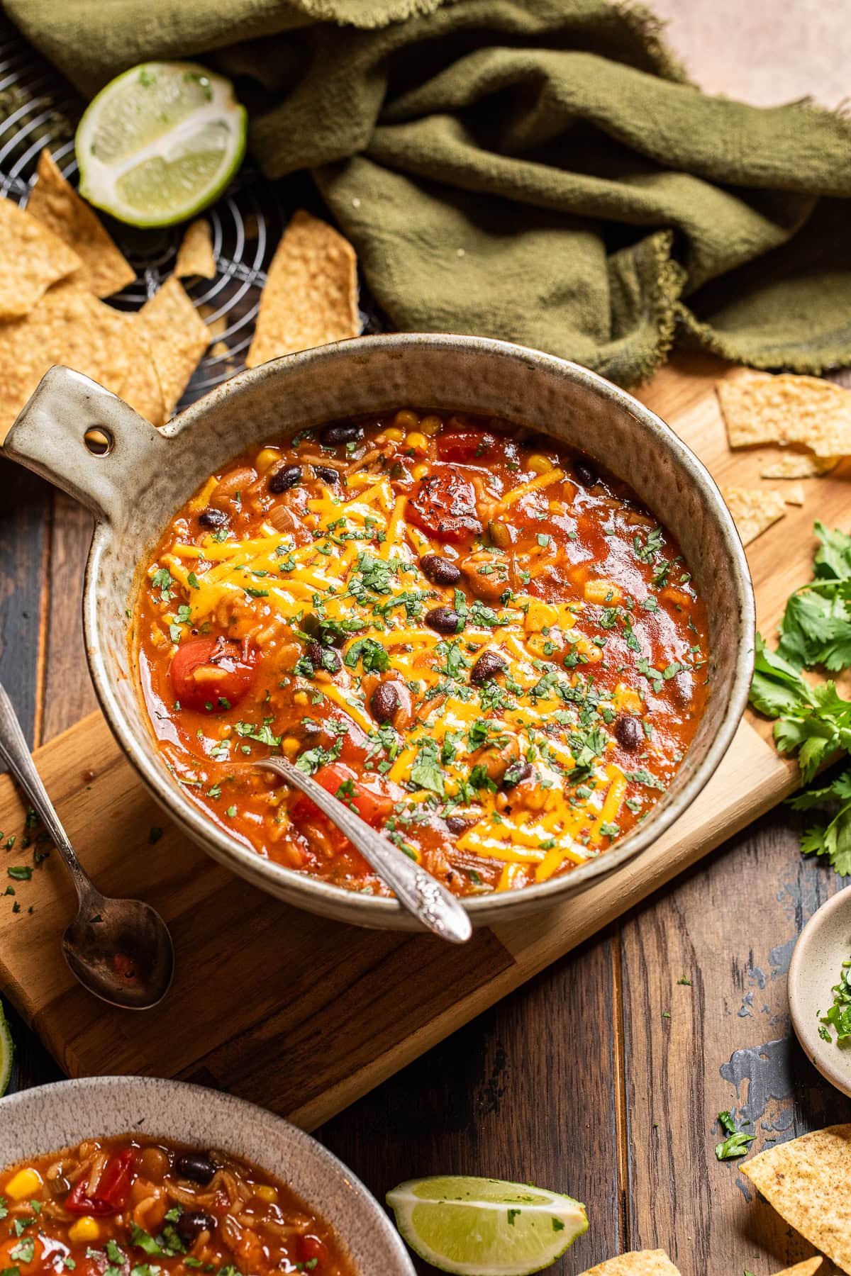 a bowl of black bean enchilada rice soup on a tablescape.