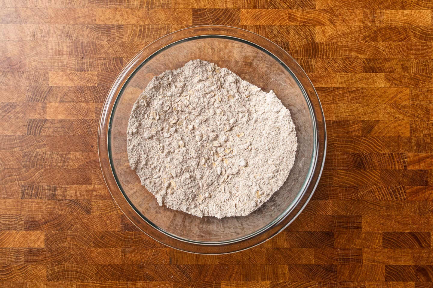 dry ingredients for baked oatmeal together in a glass bowl.