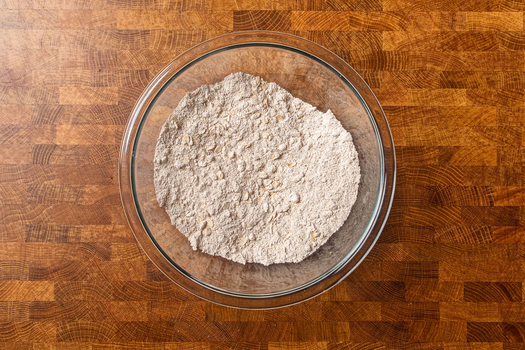 dry ingredients for baked oatmeal together in a glass bowl.
