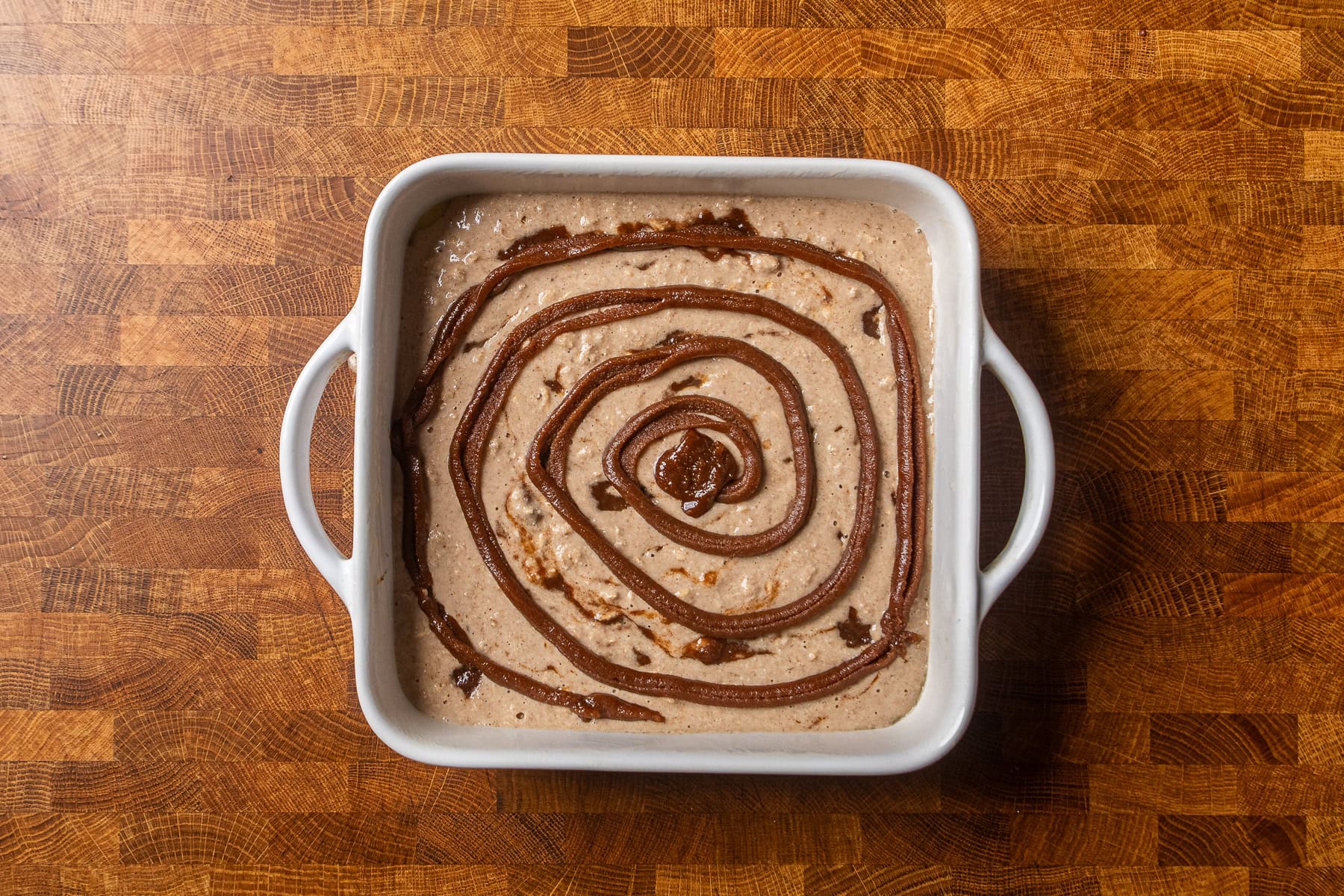cinnamon swirl baked oatmeal in a white baking dish before cooking.